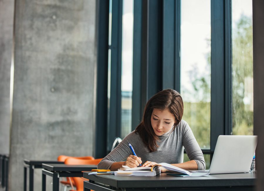 Lady studying in quiet space - library.